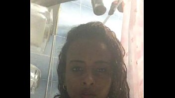 An Ethiopian girl showers naked