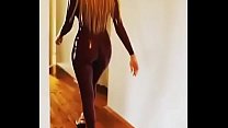 Sexy babe walks in latex catsuit