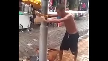 man on trying to kill a pole.