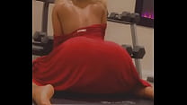 Stripper seductively shakes ass in red dress