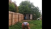 Mowing grass in sexy swimsuit