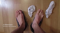 young man takes off his shoes after training and shows his smelly feet
