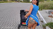 Delightful mother in blue dress without panties during street walk.