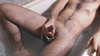 A young guy jerks off in the bath and if he holds back his moans during orgasm.