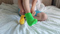 Her brightly colored mismatched socks are perfect for a sensual Sockjob